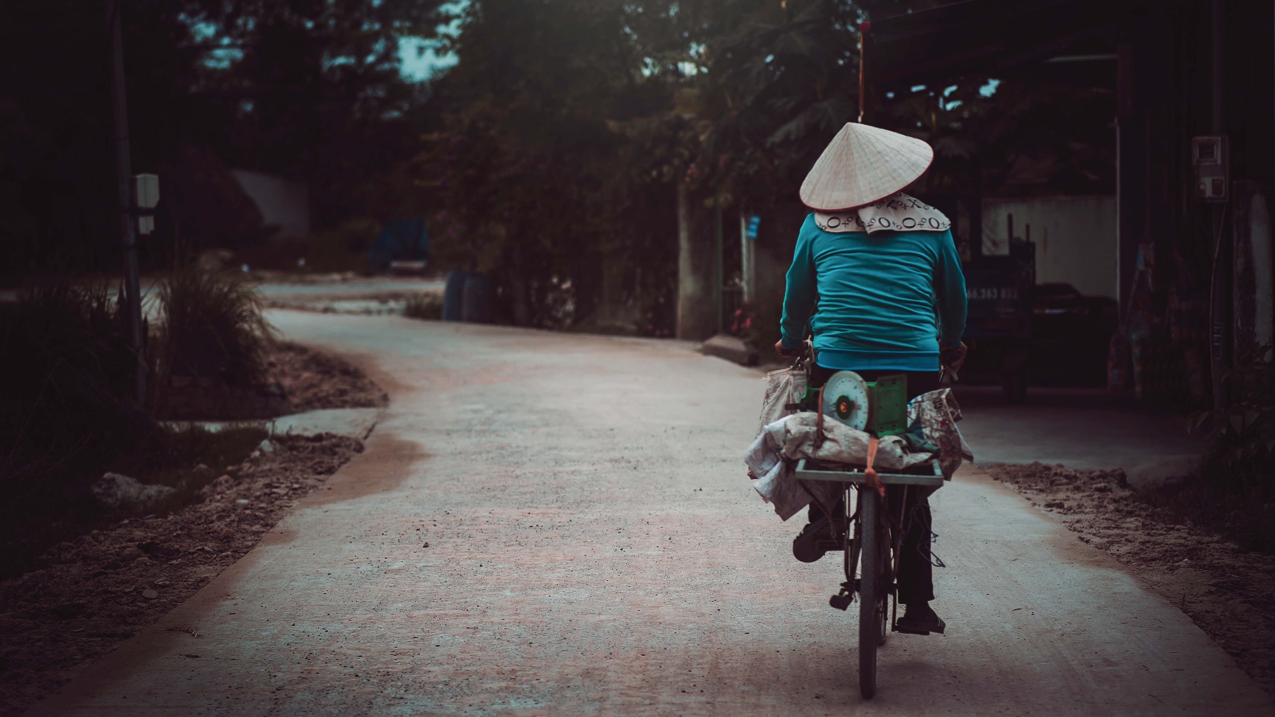 A photograph of a person from Vietnam on a bicycle